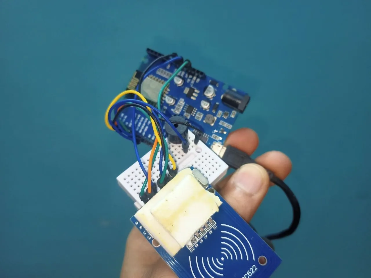 The prototype: an RC522 reader wired to the board, with a buzzer for feedback